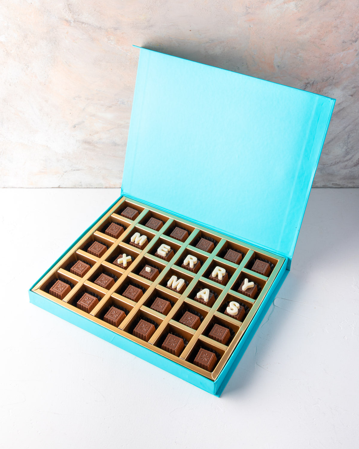 Customizable Christmas Chocolates by NJDChocolate & ConfectioneryYour Gift Contains: • 30 pieces assorted Milk chocolate Flavors: Pistachio Praline, Rice Crispy, Rocher, Sepculoos, Hazelnut Praline • Personalized text up to 18 characters (6 in each row) B