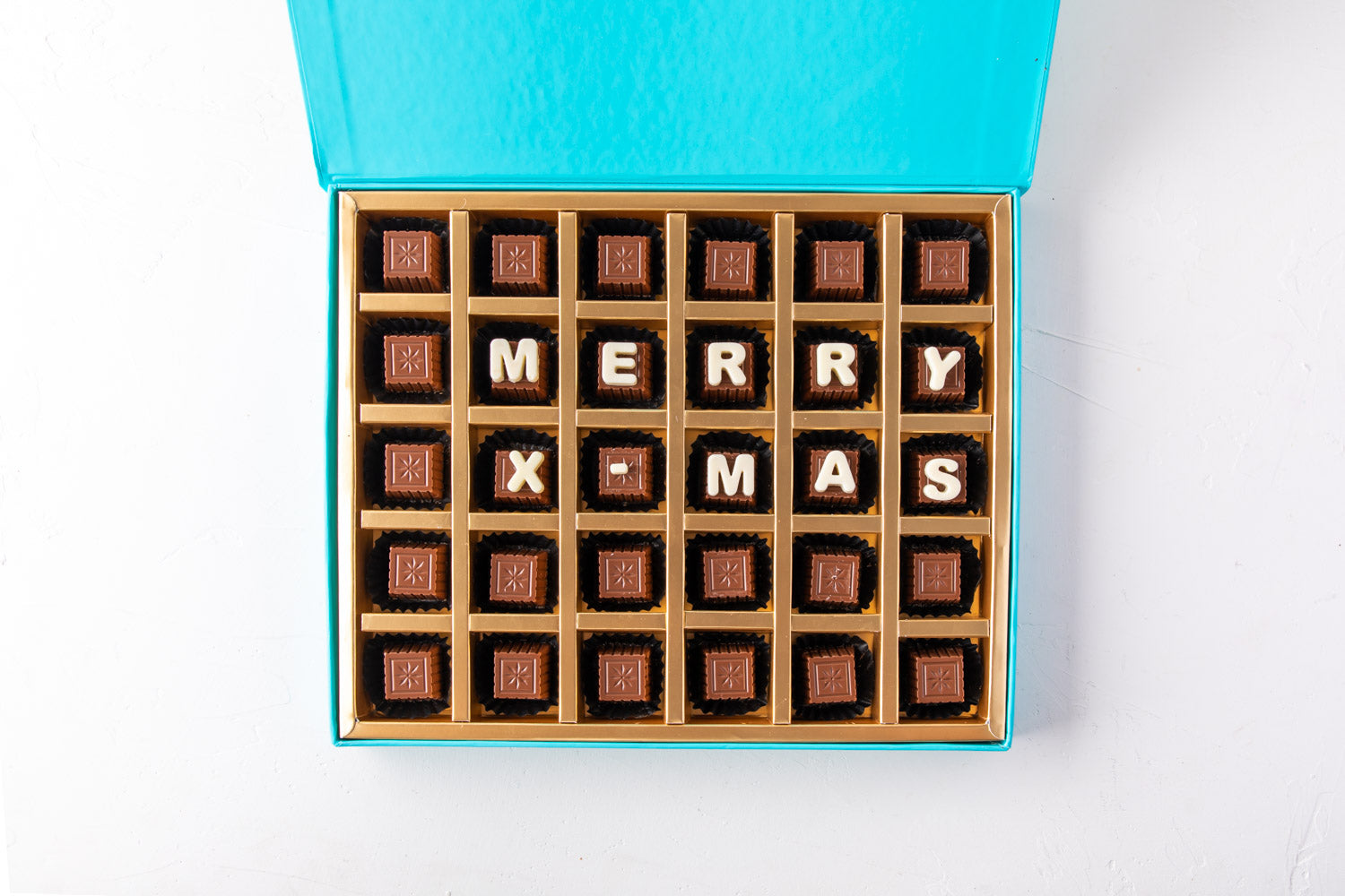 Customizable Christmas Chocolates by NJDChocolate & ConfectioneryYour Gift Contains: • 30 pieces assorted Milk chocolate Flavors: Pistachio Praline, Rice Crispy, Rocher, Sepculoos, Hazelnut Praline • Personalized text up to 18 characters (6 in each row) B