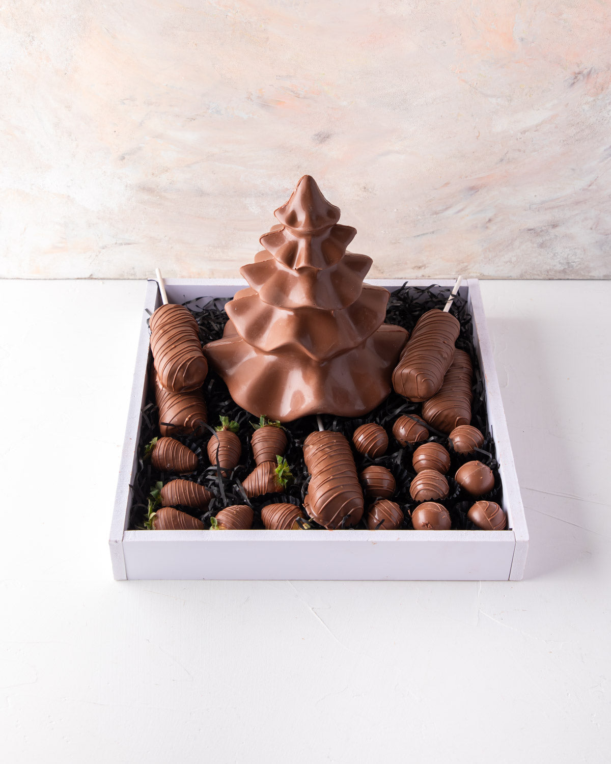 Christmas Assortment by NJDChocolate & ConfectioneryYour Gift Contains: • Tutu Edible Xmas Tree made with Milk chocolate - approx. weight 500gms • 5 sticks of Milk chocolate covered Marshmallows • 10 pieces Milk chocolate covered strawberries • 10 pieces