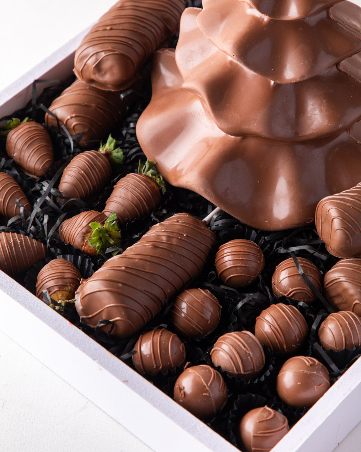 Christmas Assortment by NJDChocolate & ConfectioneryYour Gift Contains: • Tutu Edible Xmas Tree made with Milk chocolate - approx. weight 500gms • 5 sticks of Milk chocolate covered Marshmallows • 10 pieces Milk chocolate covered strawberries • 10 pieces