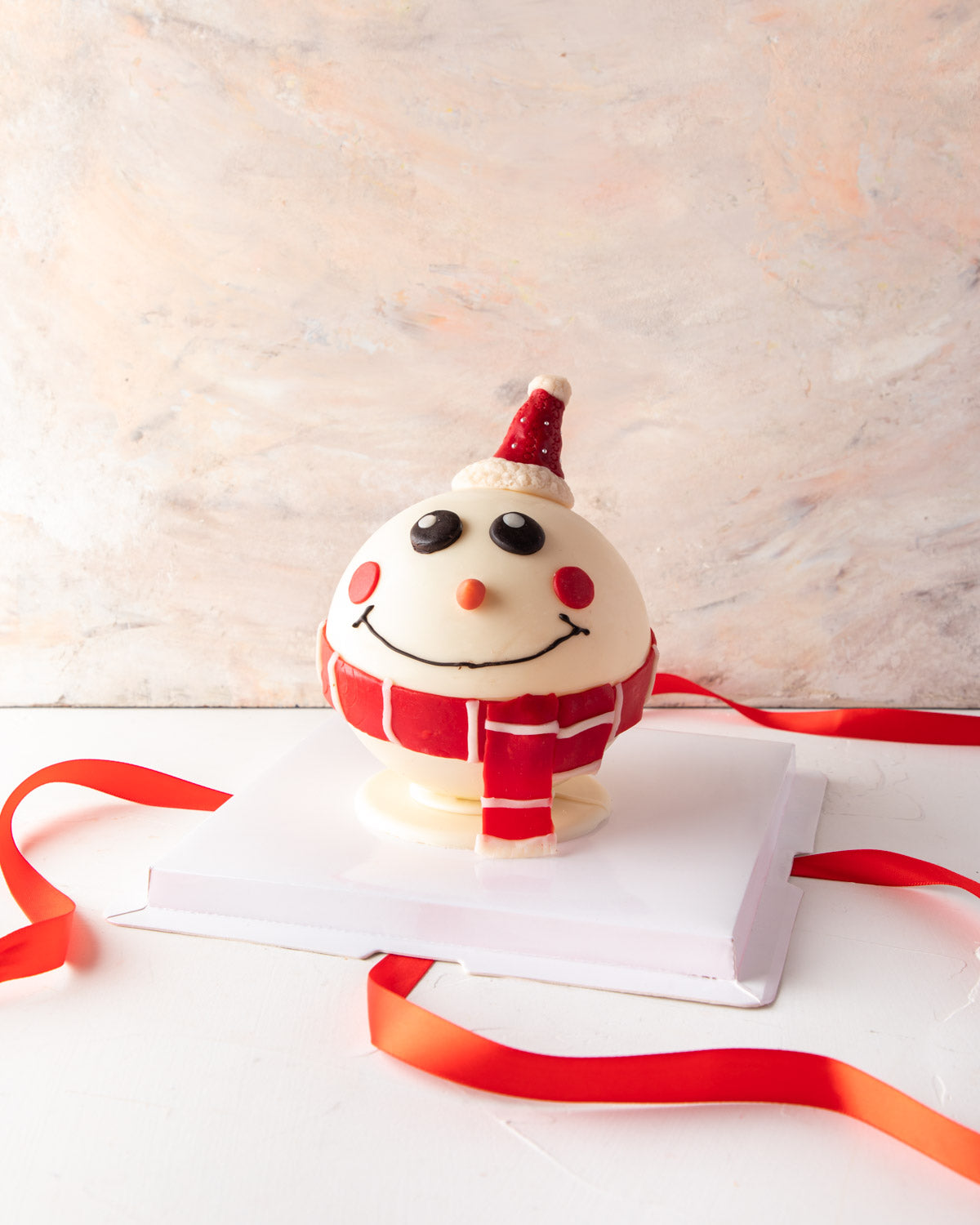 Piñata Snowman by NJDChocolate & ConfectioneryYour Gift Contains: • 3D Edible Snowman made in White and colored Chocolate • Weight approx. 300gms (20gms (+/-) • Filled with Marshmallows and 10 White assorted chocolates Box Size: LxBxH: 23.5X23.5X18cm HAND