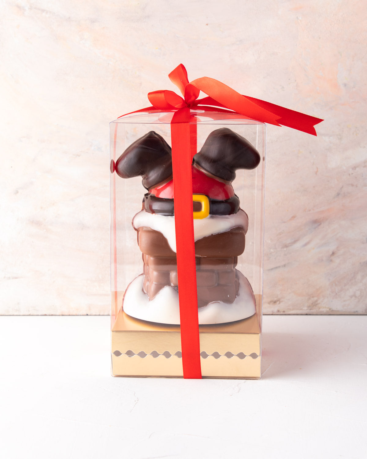 Santa comes down Chimney by NJDChocolate & ConfectioneryYour Gift Contains: • 550gms Milk and colored chocolate Santa stuck in a chimney design • chocolate size: 12.5x17cm Box Size: LxBxH: 23.5x23.5x22cm HANDLING AND STORAGE Keep away from direct heat and