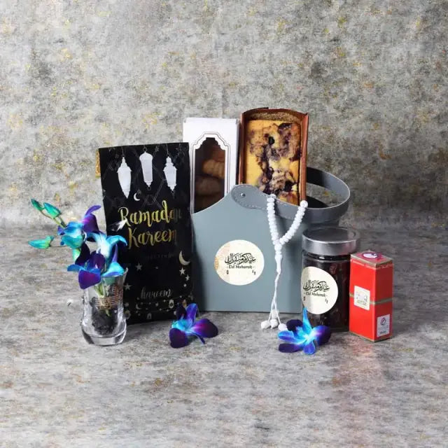 Bag of Wishes Eid HamperGifts and HampersGift Includes: Swiss Rabia Oud Oil 1 Prayer Beads Assorted Color Madjool Dates in Assorted Ramadan Kareem Pouch 100gm Dates Mamoul 5 Pcs Blueberry Loaf Cake Dried Cranberries in a Jar 200gm 1 Karak Tea Cup Arranged