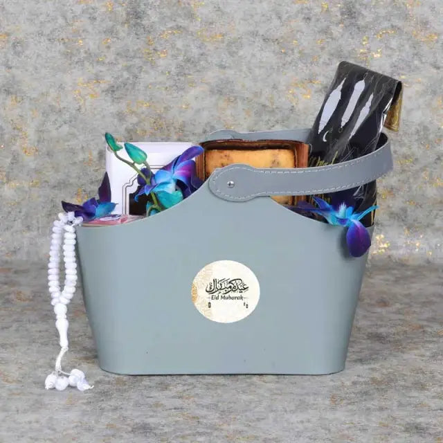 Bag of Wishes Eid HamperGifts and HampersGift Includes: Swiss Rabia Oud Oil 1 Prayer Beads Assorted Color Madjool Dates in Assorted Ramadan Kareem Pouch 100gm Dates Mamoul 5 Pcs Blueberry Loaf Cake Dried Cranberries in a Jar 200gm 1 Karak Tea Cup Arranged