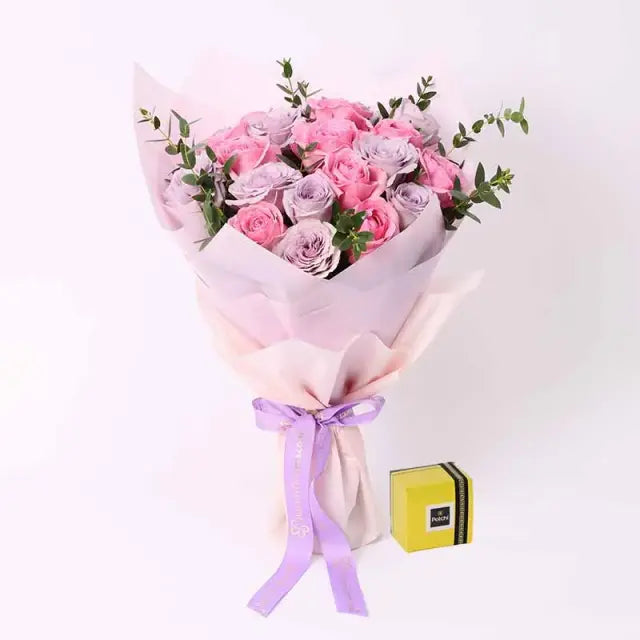 Beauty Queen 21 Roses and Deluxe Patchi ChocolatesChocolate & Confectionery250gm Deluxe Patchi Chocolates 11 Pink Roses 10 Light Purple Roses Palviforia Leaves Beautifully Wrapped and a Ribbon Bow