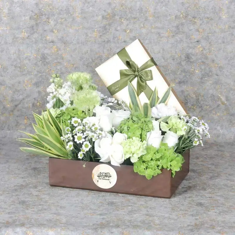 Eid Floral Hamper BrownGifts and HampersHamper Includes: Bateel Premium Stuffed Dates 450gm 9 White Roses 2 Green Hydrangea 5 Stems Green Carnations 3 Stems White Matthiola 3 Stems White Chrysanthemum Leaves - 2 Stems Song of India and 3 Stems Eucalyptus