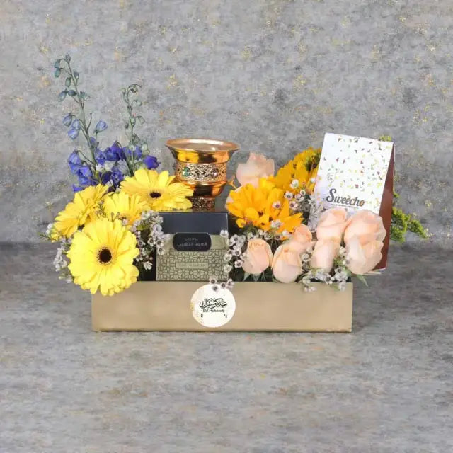Eid Floral Hamper GoldenGifts and HampersHamper Includes: Premium Chocolates By Sweecho 100gm Swiss Arabia Bakhoor 1 Box 1 Bakhoor Burner 9 Peach Roses 4 Stems Yellow Gerbera 3 Sunflowers 2 Stems Dark Blue Delphinium 2 Stems White Wax Leaves - 3 Stems Sol