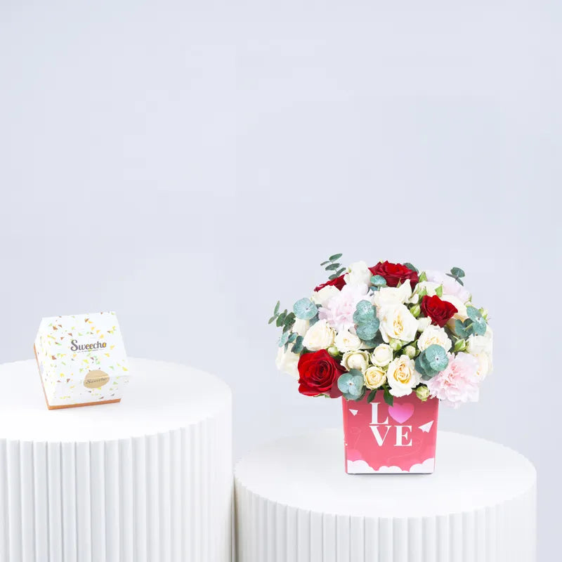 Valentine flower arrangement with chocolate