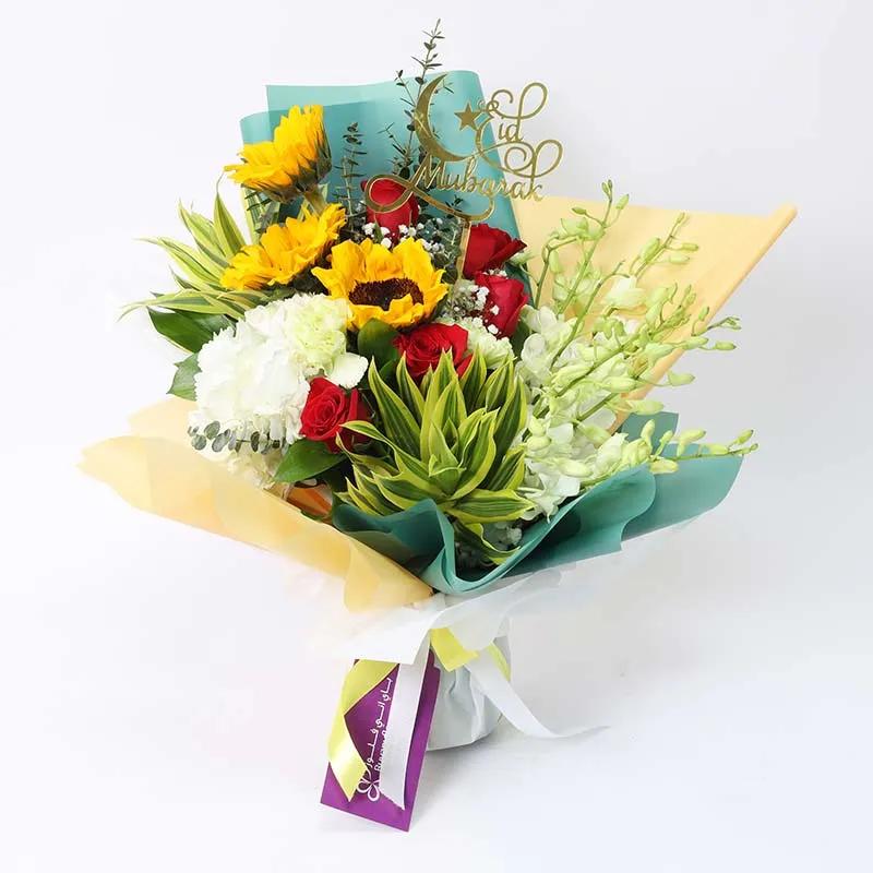 Eid Floral Blessings Bouquet GreenFlowersProduct Description 1 White Hydrangea 5 Red Roses 3 Sunflowers 5 Green Carnations 6 White Orchids Leaves and Fillers - 2 Song of India, 2 Eucalyptus, Parvifolia Gypso and 3 Single Ruscus 1 Eid Mubarak Topper Green