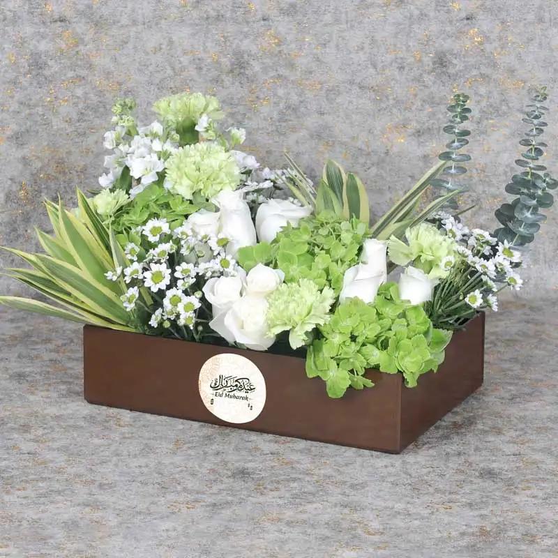 Floral Eid Wishes BrownChocolate & ConfectioneryProduct Description 9 White Roses 2 Green Hydrangea 5 Stems Green Carnations 3 Stems White Matthoila 3 Stems White Chrysanthemum Leaves - 2 Stems Songs of India and 3 Stems Eucalyptus Prepeared in a Brown Ac