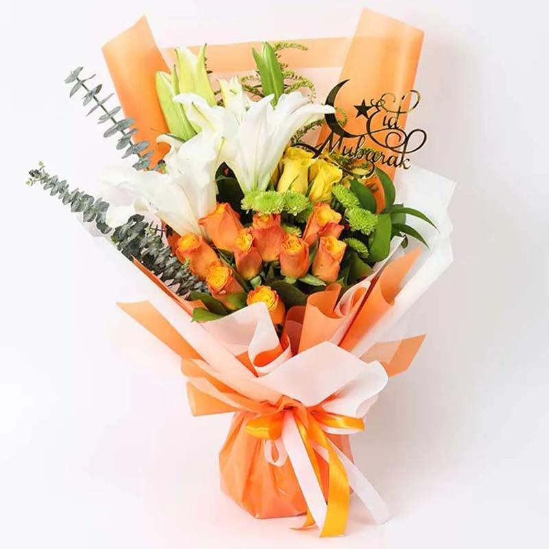 Eid Floral Blessings Bouquet OrangeChocolate & ConfectioneryProduct Description 9 Orange Roses 6 Yellow Roses 2 Stems White Oriental Lilies 2 Stems Green Button Chrysanthemums Leaves and Fillers - 2 Stems Solidago, 3 Eucalyptus 2 Stems Single Ruscus 1 Eid