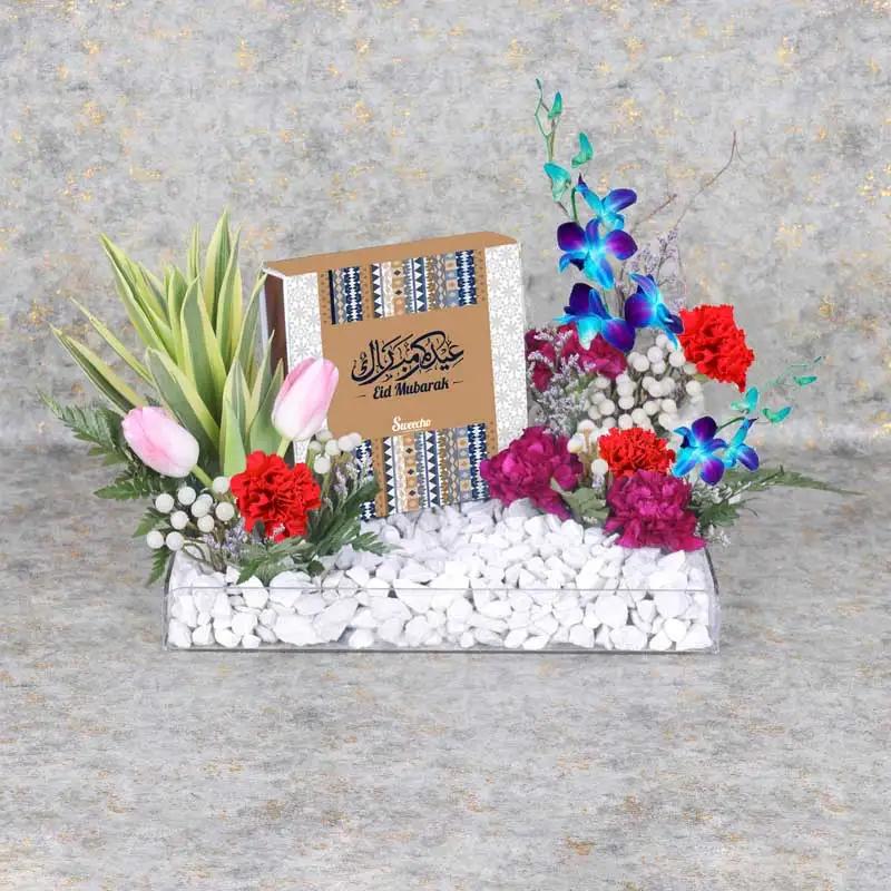 Eid Flower Chocolate Tray BlueChocolate & ConfectioneryProduct Description Eid Premium Assorted Stuffed Dates By Sweecho 16 Pcs 2 Pink Tulips 3 Stems Red Carnations 3 Stems Dark Purple Carnations 2 Stems Blue Orchids Fillers - 2 Stems Silver Brunia and 2