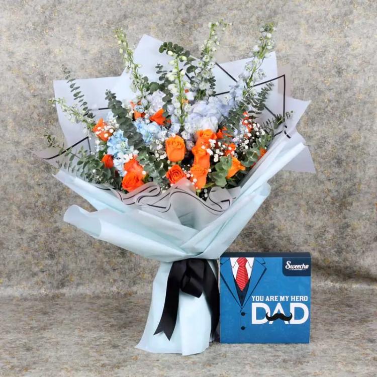 Fantastic Flower Bouquet and Assorted ChocolatesChocolate & ConfectioneryPremium Assorted Chocolates 16 Pcs By Sweecho, 4 Blue Hydrangeas, 5 Blue Delphinium, 22 Orange Roses, Leaves : 10 Eucalyptus, Wrapped in Sky Blue and White Wrapping, Tied with Black