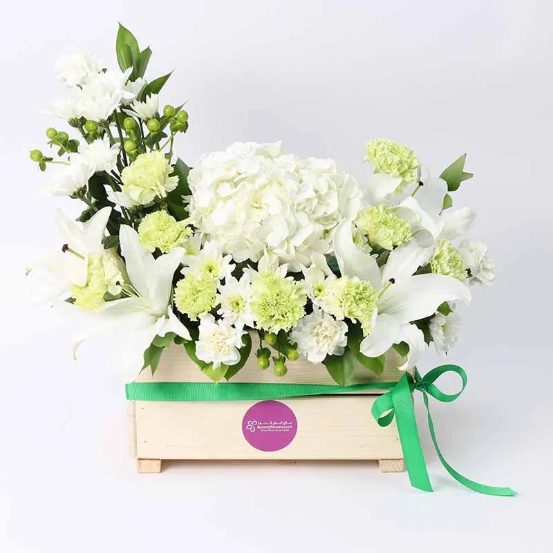 Peaceful BlessingsChocolate & ConfectioneryProduct Description 1 White Hydrangea 2 Stems White Oriental Lilies 9 Green Carnations 4 White Carnations 3 Stems White Chrysanthemums 3 Stems Green Hypericum Leaves and Fillers - 5 Single Ruscus 1 Crescent Moon