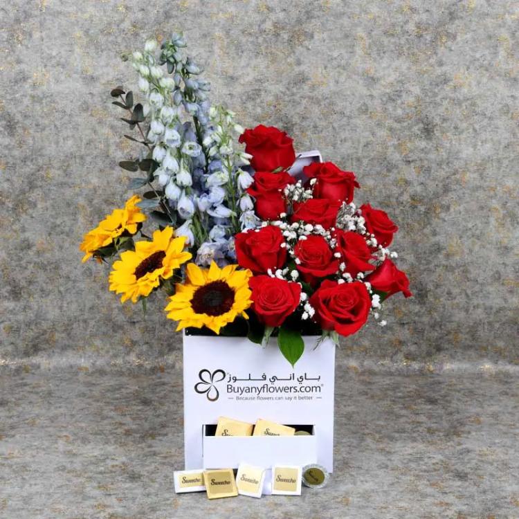 Icon Flowers and Chocolate BoxChocolate & ConfectioneryPremium Assorted Chocolates 100 gm By Sweecho, 3 Blue Delphinium, 3 Sunflowers, 11 Red Roses, Leaves: 3 Eucalyptus and 3 Single Ruscus, Fillers : 2 Gypso, Prepared in Square White Box.