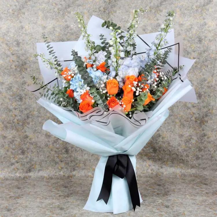 Fantastic Roses and Hydrangea BouquetChocolate & Confectionery4 Blue Hydrangeas, 5 Blue Delphinium, 22 Orange Roses, Leaves : 10 Eucalyptus, Fillers : 2 Gypso, Wrapped in Sky Blue and White Wrapping, Tied with Black Ribbon Bow.