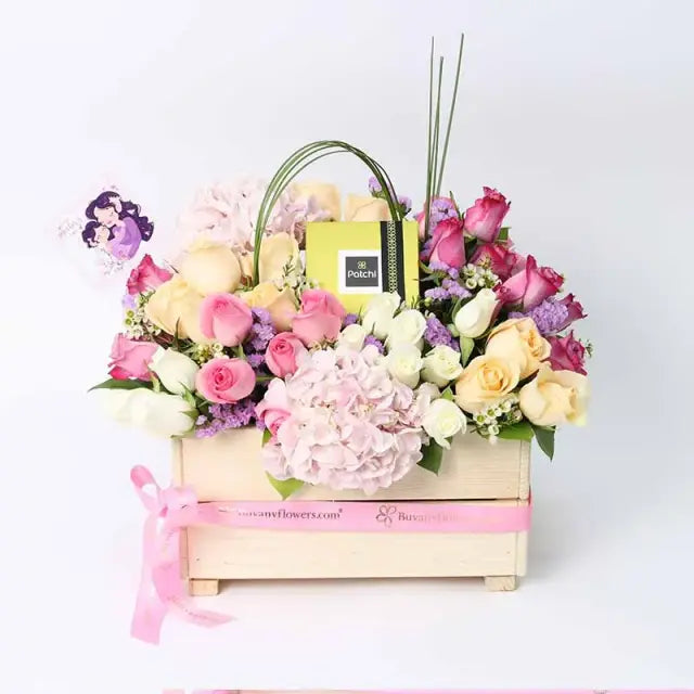 Mothers Day Abundance Mix Flowers and PatchiChocolate & Confectionery2 Pink Hydrangeas 10 Purple Roses 10 Pink Roses 10 Peach Roses 10 White Roses 2 Stems Purple Statice 1 Stem White Wax Flower Leaves - 5 Steel Grass and 3 Single Ruscus 250gm Premium Patc