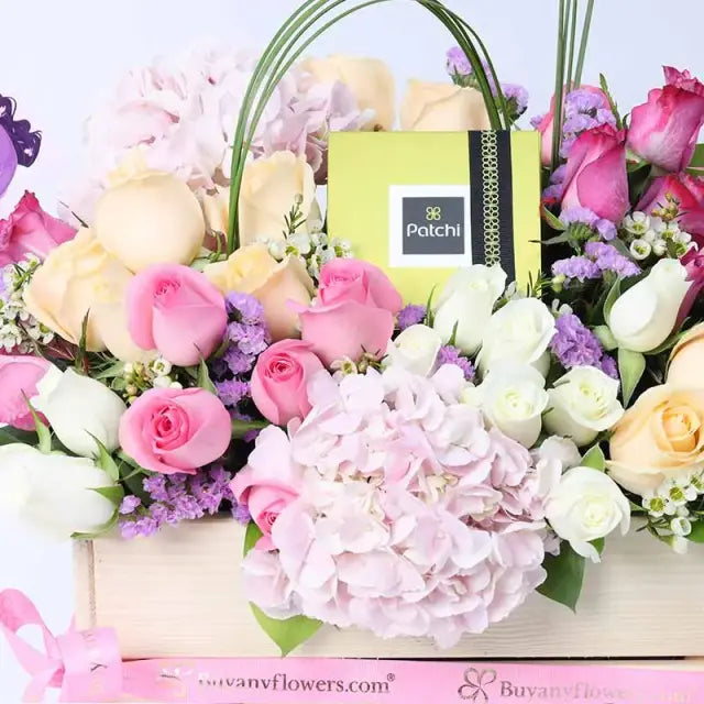 Mothers Day Abundance Mix Flowers and PatchiChocolate & Confectionery2 Pink Hydrangeas 10 Purple Roses 10 Pink Roses 10 Peach Roses 10 White Roses 2 Stems Purple Statice 1 Stem White Wax Flower Leaves - 5 Steel Grass and 3 Single Ruscus 250gm Premium Patc