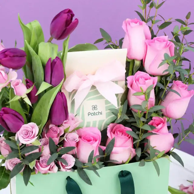 Purple and Pink Patchi Floral ArrangementGifts and HampersDeluxe Patchi Chocolates 100gm 6 Purple Tulips 7 Pink Roses 4 Stems Purple Baby Roses Leaves - 1 Stem Palviforia Prepared in Patchi Bag