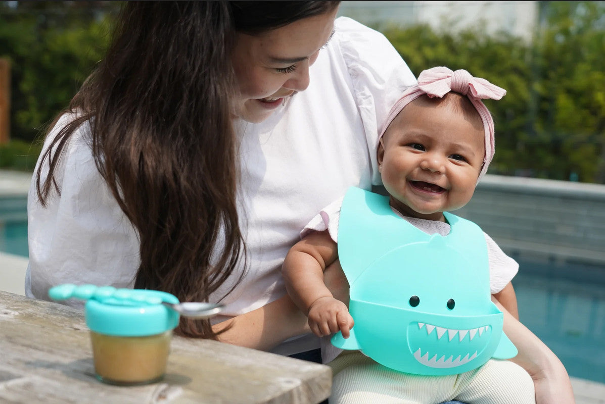 Meli Silicone Bib - Turquoise SharkNursing & FeedingWith our Silicone Shark Bib your little one can eat (and stay clean!) in adorable style! Our playful, cute Shark bib is waterproof and makes feeding and mealtime fun! Made of soft high-quality 100% food