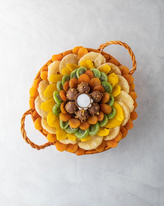 Dried Fruits Hamper by NJDNuts, Dates & Dried FruitsYOUR GIFT CONTAINS Content: Dried Pineapple 700gms Dried Kiwis 180gms Dried Apricot 500gms Assorted Truffles 8pcs Dried Mango 150gms Diya (1pc) Flavor: Assorted truffles with Praline, Ganache, Caramel fi