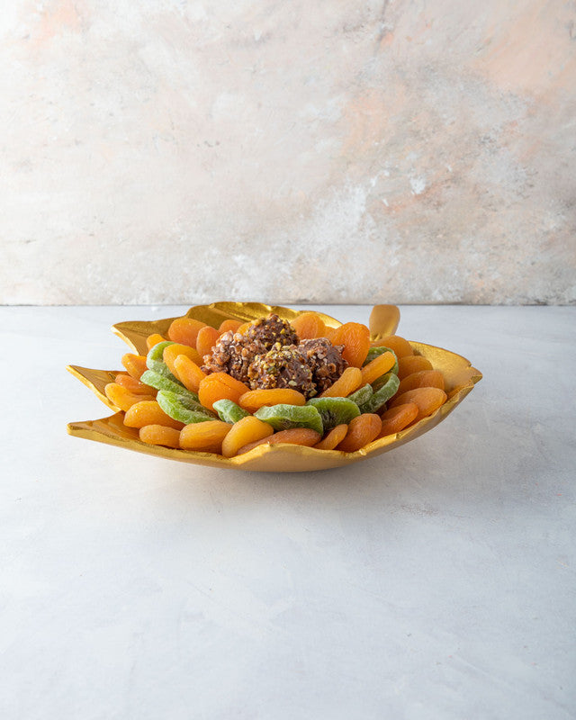The Golden leaf by NJDNuts, Dates & Dried FruitsYOUR GIFT CONTAINS Content: Dried Kiwis 150gms Dried Apricot 500gms Assorted Truffles - 4pcs Flavors: Assorted truffles with Praline, Ganache and caramel fillings Tray dimensions: Wide: 25cm Height: 26.5cm H