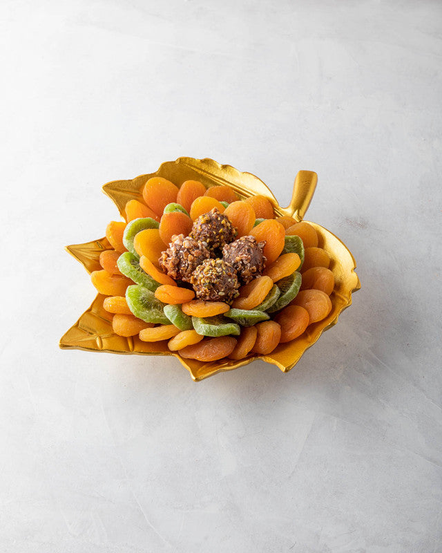 The Golden leaf by NJDNuts, Dates & Dried FruitsYOUR GIFT CONTAINS Content: Dried Kiwis 150gms Dried Apricot 500gms Assorted Truffles - 4pcs Flavors: Assorted truffles with Praline, Ganache and caramel fillings Tray dimensions: Wide: 25cm Height: 26.5cm H