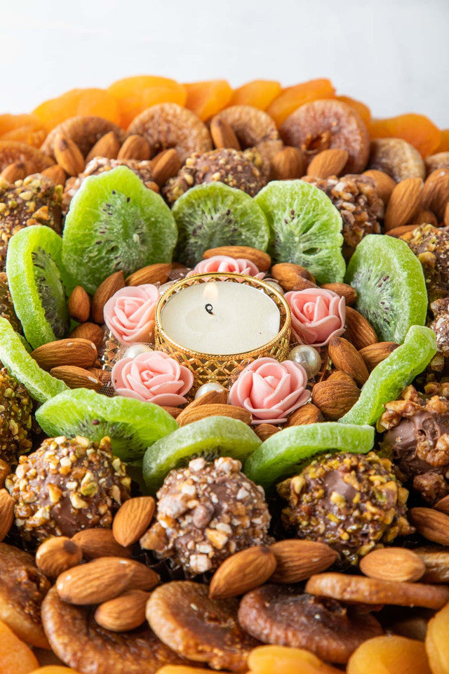 Assorted Dried Fruits Arrangement by NJDNuts, Dates & Dried FruitsYOUR GIFT CONTAINS Content: Dried Figs 250 gms Dried Kiwis 150 gms Dried Apricot 350 gms Almonds 100 gms Truffles 12 pcs Diya 1 pcs (design may vary) Flavors: Truffles - with caramelized Pi