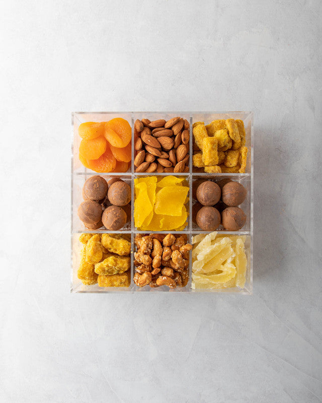 Diwali Gift Box by NJDNuts, Dates & Dried FruitsYOUR GIFT CONTAINS Content (approx.): Apricot 80gms Almonds 80gms Savory 150gms Indian savory snack with sesame seeds Truffles 16pcs assorted Dried Mango 80gms Caramelized Cashews 90gms Dried Pineapple 90gms