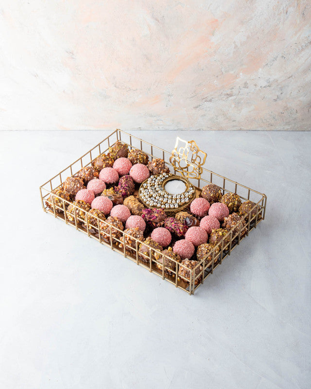 Luxury Diwali Gift by NJDNuts, Dates & Dried FruitsYOUR GIFT CONTAINS Content: 6pcs Chocolate Dates 18pcs Roasted Nuts Truffles 14pcs Rose truffles 1 Designer Diya - (design may vary) Flavors: Dates: rose, caramelized nuts Assorted truffles coated with ca