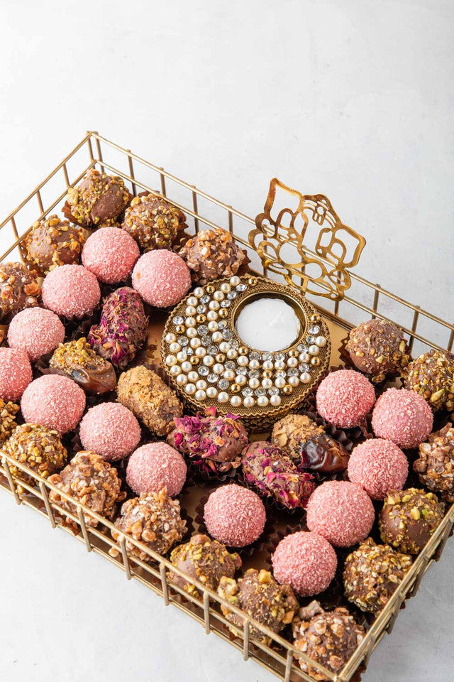 Luxury Diwali Gift by NJDNuts, Dates & Dried FruitsYOUR GIFT CONTAINS Content: 6pcs Chocolate Dates 18pcs Roasted Nuts Truffles 14pcs Rose truffles 1 Designer Diya - (design may vary) Flavors: Dates: rose, caramelized nuts Assorted truffles coated with ca