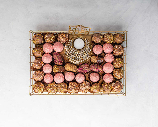 Luxury Diwali Gift by NJDNuts, Dates & Dried FruitsYOUR GIFT CONTAINS Content: 6pcs Chocolate Dates 18pcs Roasted Nuts Truffles 14pcs Rose truffles 1 Designer Diya - (design may vary) Flavors: Dates: rose, caramelized nuts Assorted truffles coated with ca