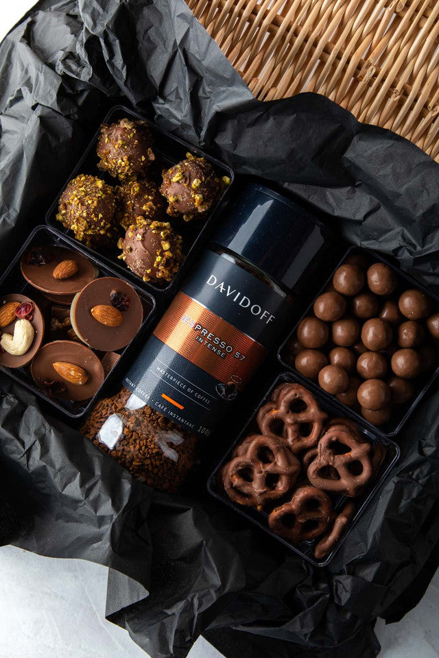 Diwali Gift Hamper by NJDChocolate & ConfectioneryYOUR GIFT CONTAINS Content: Davidoff Coffee - 100gms Truffles - 8 pcs Assorted Biscoff balls - 150gms Chocolate covered Pretzels - 100gms Chocolate discs 150gms Flavors: Assorted truffles with roasted nuts
