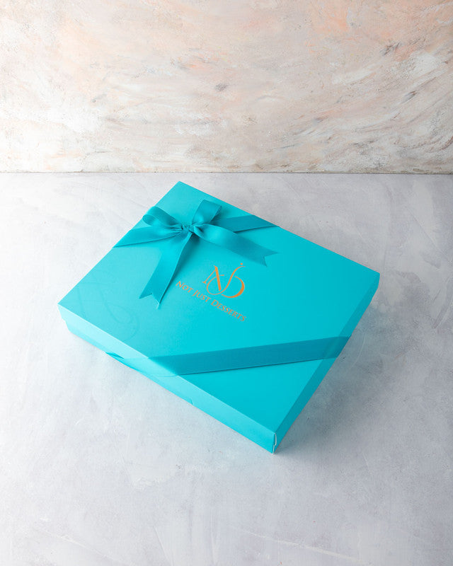 Diwali Swastik Collection by NJDChocolate & ConfectioneryYOUR GIFT CONTAINS Content: 22pcs Truffle 1kg Drageè Flavors: Assorted Belgian Truffles filled with caramelized Pistachio, Almonds, Nutella, Lotus, Peanut Butter and Salted Caramel Box dimensions: W