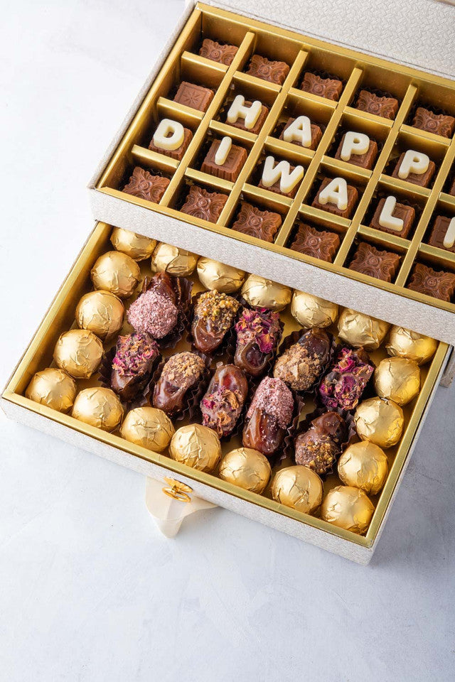 Diwali Gift by NJDChocolate & ConfectioneryYOUR GIFT CONTAINS Content: Assorted Chocolates 24pcs Assorted Dates 12pcs Assorted Belgian Chocolate Truffles 20pcs Flavors Belgian milk chocolates with Nutella, Hazelnut, Pralines, Ganache, Caramel and Biscoff