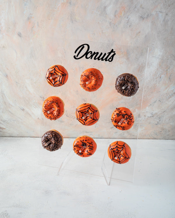 Halloween Donut WallChocolate & Confectionery9pcs Halloween doughnuts comes packed on the wall as seen in the picture Wall dimensions: Wide: 30cm Height: 40cm HANDLING AND STORAGE Keep away from direct heat and sunlight All our products are made to order