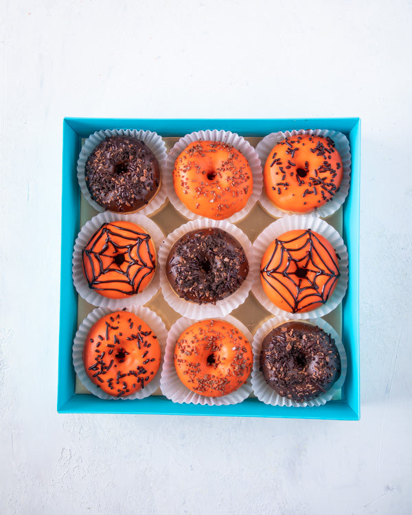 Donuts of the DoomChocolate & ConfectioneryHalloween donuts are a fun and festive treat to this season! The box contains 9pcs fresh donuts hand designed and glazed with chocolate. Packed as shown in the picture Box dimensions: length: 24cm wide: 24cm HAND