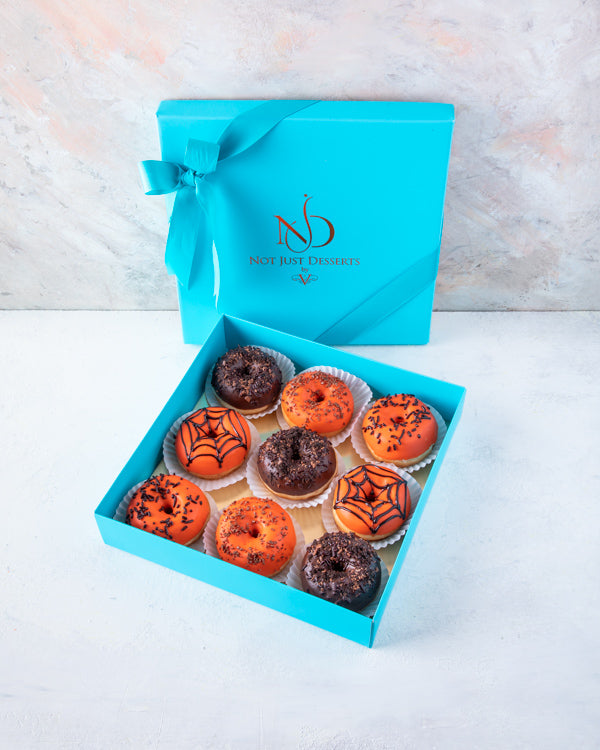 Donuts of the DoomChocolate & ConfectioneryHalloween donuts are a fun and festive treat to this season! The box contains 9pcs fresh donuts hand designed and glazed with chocolate. Packed as shown in the picture Box dimensions: length: 24cm wide: 24cm HAND