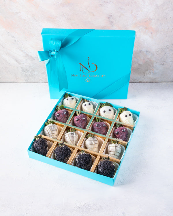 Mummy & Creepy StrawberryChocolate & Confectionery16pcs dressed-up strawberries, dipped in colored chocolate and Dark chocolate. Hand designed, decorated with edible glitter Packed as shown in the picture Box dimensions: length: 24cm wide: 24cm HANDLING A