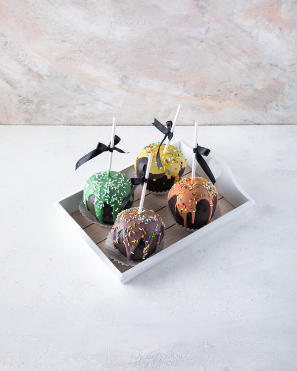 Trick or Treat ApplesChocolate & Confectionery4 dress up traditional caramel apples with colorful chocolate dripping makes an eye-catching Halloween treat. Tray dimensions: length: 19cm wide: 24cm HANDLING AND STORAGE Keep away from direct heat and sunlig