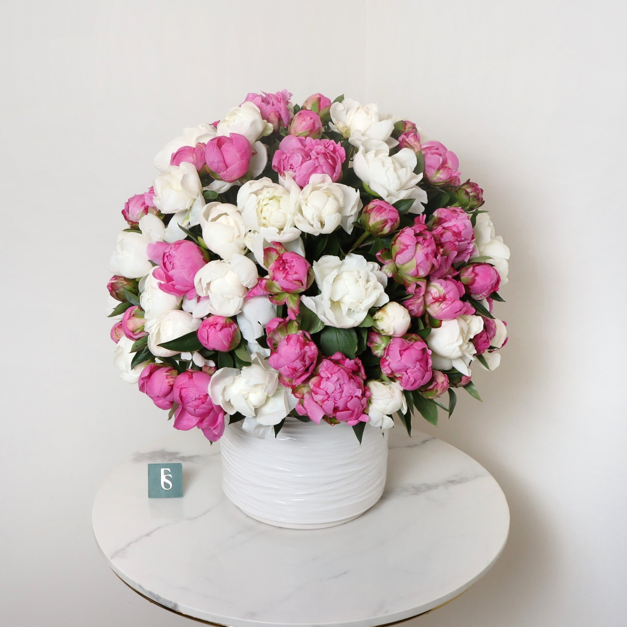100 Peony VaseSame-day delivery Own a stunning piece of art with our 100 Peony Vase. Crafted with 100 individual peonies, this vase is a beautiful addition to any home or office. Each flower is carefully placed to create a truly unique and eye-catching ar