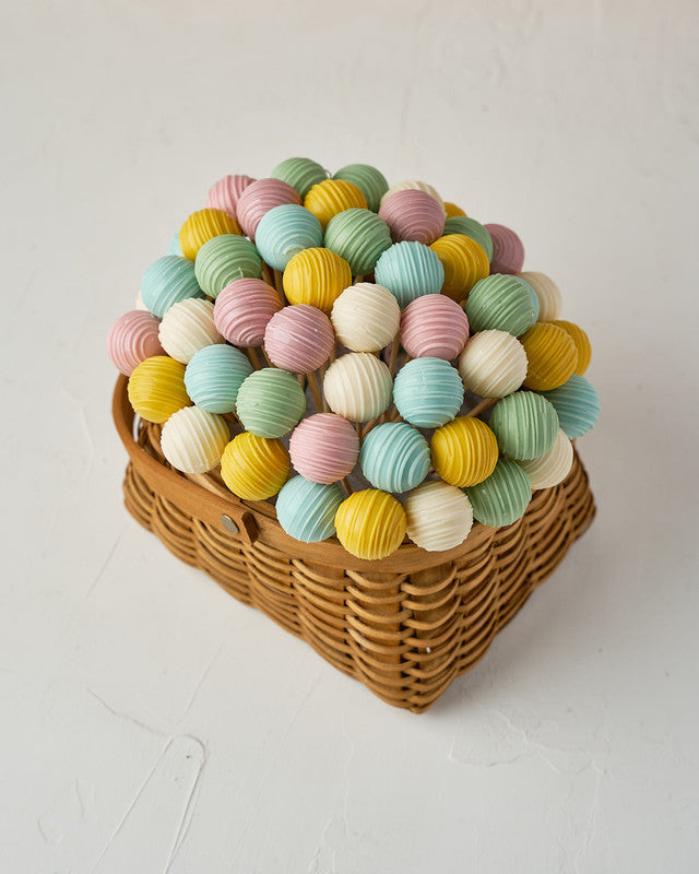 Spring Truffle BasketChocolate & ConfectioneryYour Gift Contains: • 53 assorted truffles • Flavors: Pistachio, Sepculoos, Hazelnut, Rice Crispy, Peanut Butter, Kinder and Roche • Basket Size: 15x20x12 cm Handling and Storage • Keep away from direct heat a