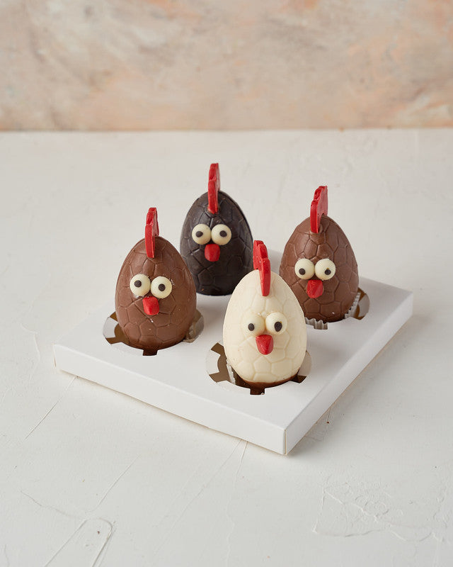 Chocolate RoostersChocolate & ConfectioneryYour Gift Contains: • 2 Milk Chocolate Roosters • 1 Dark chocolate Rooster • 1 White chocolate Rooster • Weigh: 600 grams approx. • Box Size: 18x18x15cm Handling and Storage • Keep away from direct heat and sunli