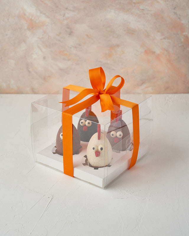 Chocolate RoostersChocolate & ConfectioneryYour Gift Contains: • 2 Milk Chocolate Roosters • 1 Dark chocolate Rooster • 1 White chocolate Rooster • Weigh: 600 grams approx. • Box Size: 18x18x15cm Handling and Storage • Keep away from direct heat and sunli