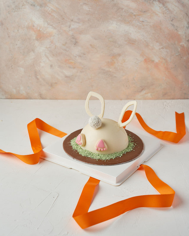 Bunny DiggingChocolate & ConfectioneryYour Gift Contains: • 200grams white chocolate Pinata • 8 assorted truffles in Kinder, Pistachio and Biscoff flavors • 1 x Hammer • Box Size: 23x23x26 cm Handling and Storage • Keep away from direct heat and sunlight