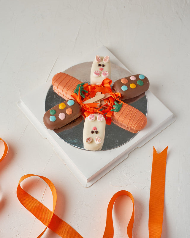 6 Easter Theme CakesiclesChocolate & ConfectioneryYour Gift Contains: • 3 Red Velvet and 3 Vanilla Cakesicles • Designed as carrots and bunny • Box Size: 23x23x14cm Handling and Storage • Keep away from direct heat and sunlight • Best stored between 8-15