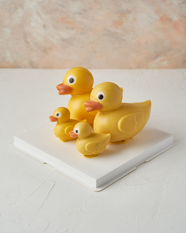 Chocolate DuckChocolate & ConfectioneryYour Gift Contains: • Edible Duck family made with colored and milk chocolate • Chocolate Weight: 510 grams approx. • Duckling size: 6×4.5×7.5cm • Duck size: 11.2x8x13.6cm • Box Size: 23.5x23.5x15 Handling and Storag