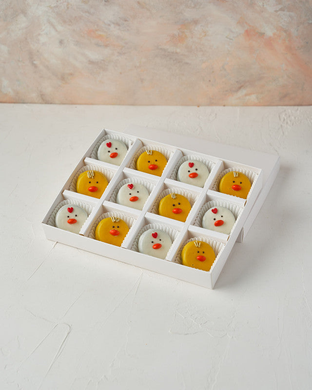 Easter Oreo ChicksChocolate & ConfectioneryYour Gift Contains: • 12 White and colored chocolate covered Oreos designed as chicks • Box Size: 24x18x3.5cm Handling and Storage • Keep away from direct heat and sunlight • Best stored between 8-15 °C • Suitabl