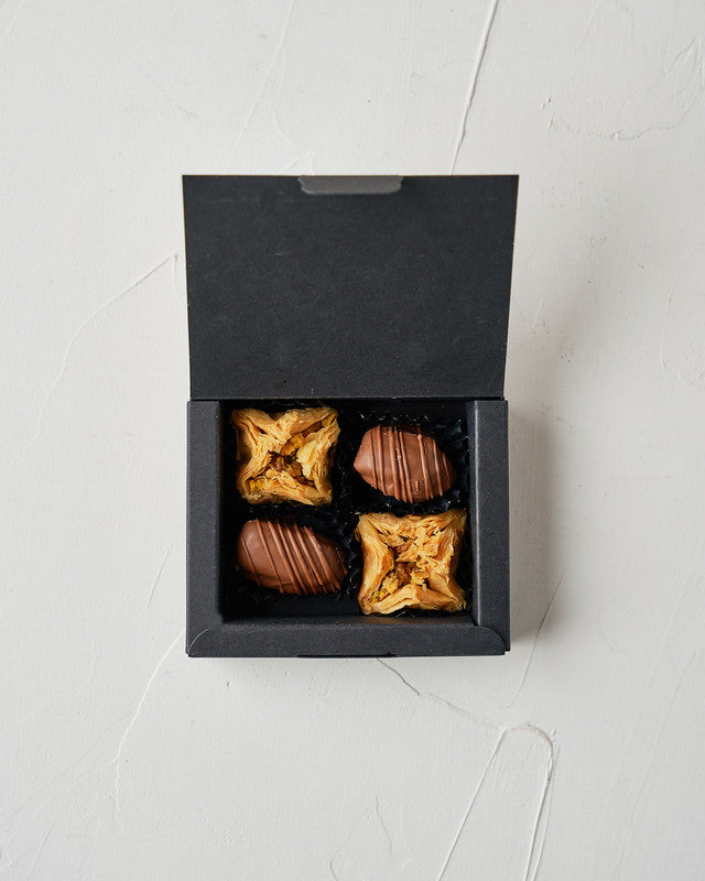 Small Dates and Baklawa BoxChocolate & ConfectioneryYour Gift Contains: • 2 Belgian Milk chocolate covered majdoul Dates • 2 pieces Pistachio Baklawa • Box Size: LxBxH: 10x8x2.3cm Handling and Storage • Keep away from direct heat and sunlight • Best store