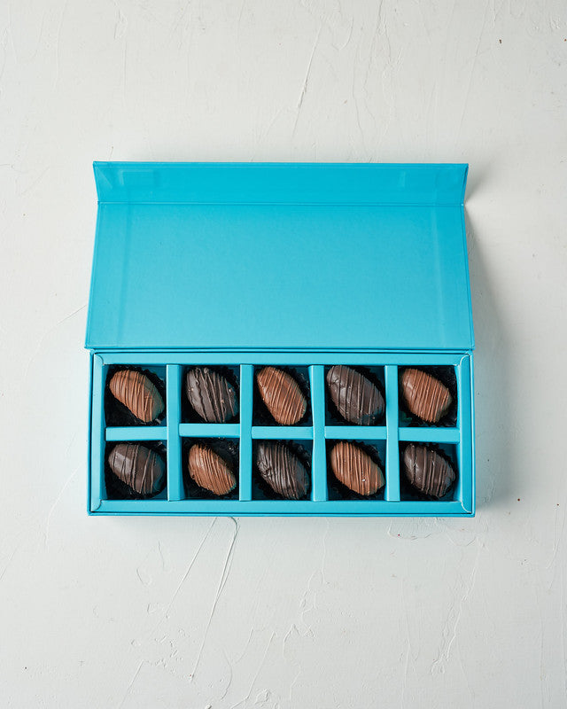 Small Milk and Dark Chocolate Dates by NJDChocolate & ConfectioneryYour Gift Contains: • 5 pure, rich Belgian Milk chocolate covered Majdoul dates • 5 pure, rich Belgian Dark chocolate covered Majdoul dates • Box Size: LxBxH: 28.5x12x4cm Handling and Stor